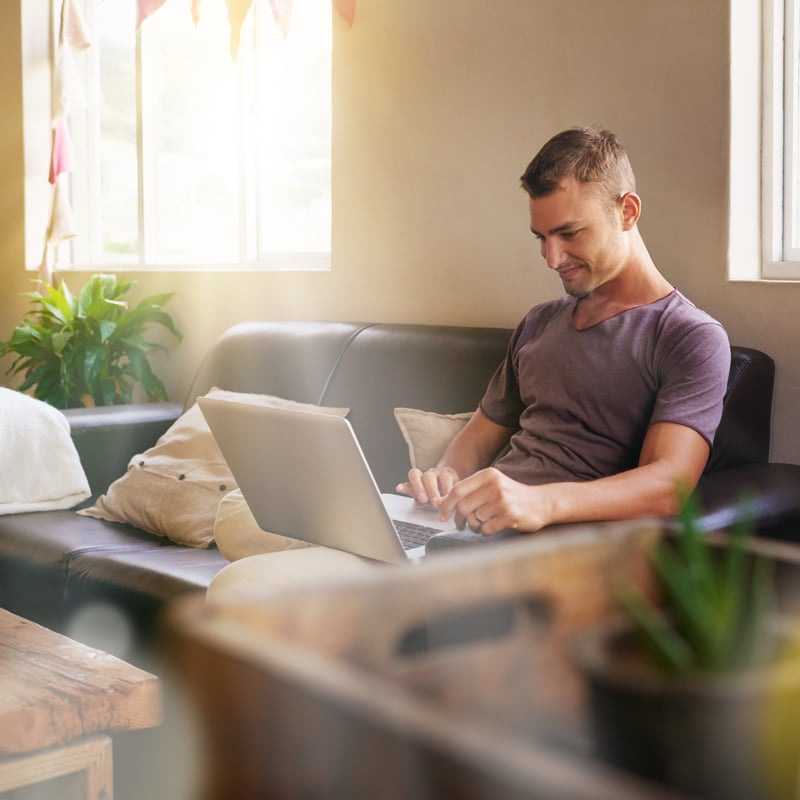 Man working remotely on his couch