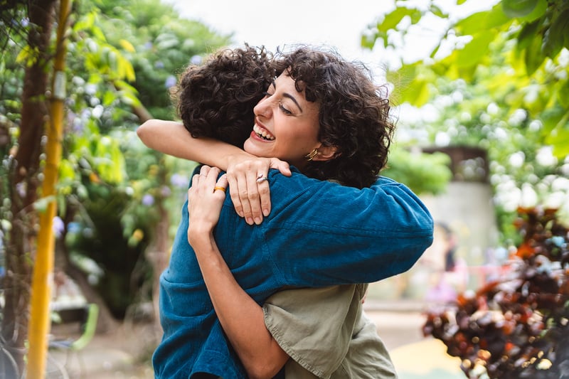 Two People Hugging in Nature Setting