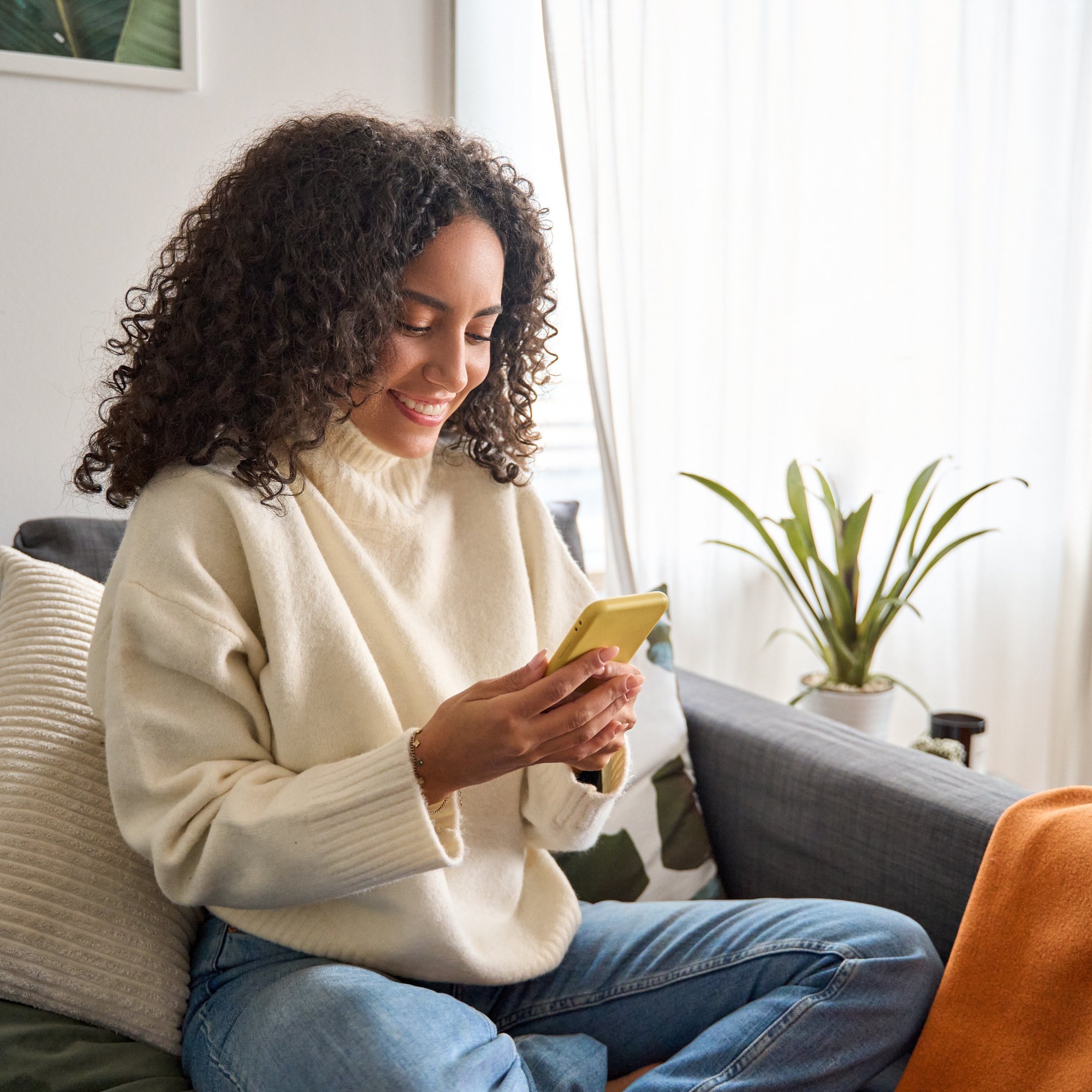 Young woman looking at her phone and smiling